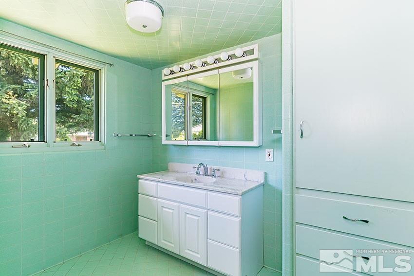 375 Chevy Chase Street Reno, NV 89509 - Photo 18 of 25 a bathroom with a sink and a mirror