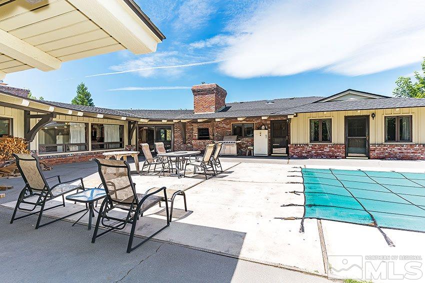 375 Chevy Chase Street Reno, NV 89509 - Photo 22 of 25 a view of a patio with dining table and chairs under an umbrella