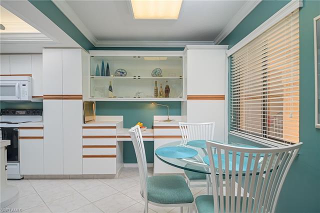 4120 Lorene Drive, Unit 101 Estero, FL 33928 - Photo 12 of 45 a room with a chair and white cabinets