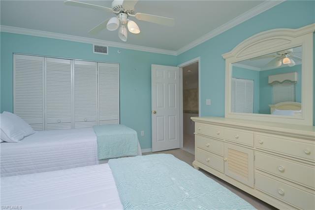 4120 Lorene Drive, Unit 101 Estero, FL 33928 - Photo 21 of 45 a spacious bedroom with a large bed and a chandelier