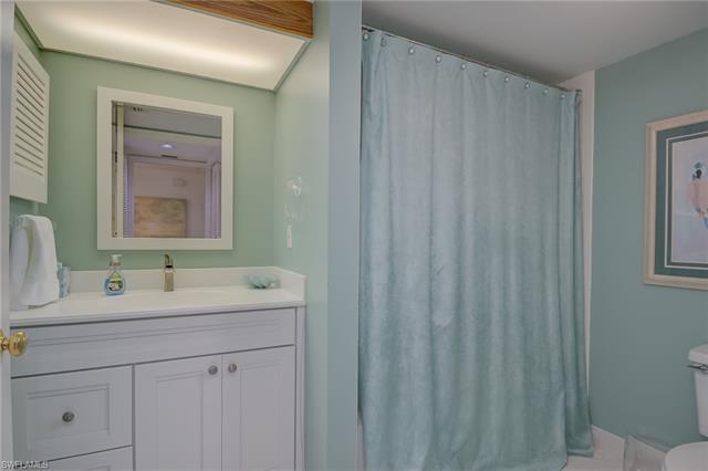 4120 Lorene Drive, Unit 101 Estero, FL 33928 - Photo 22 of 45 a bathroom with a sink and a mirror