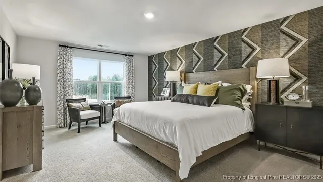 a bed sitting in a bedroom next to a window