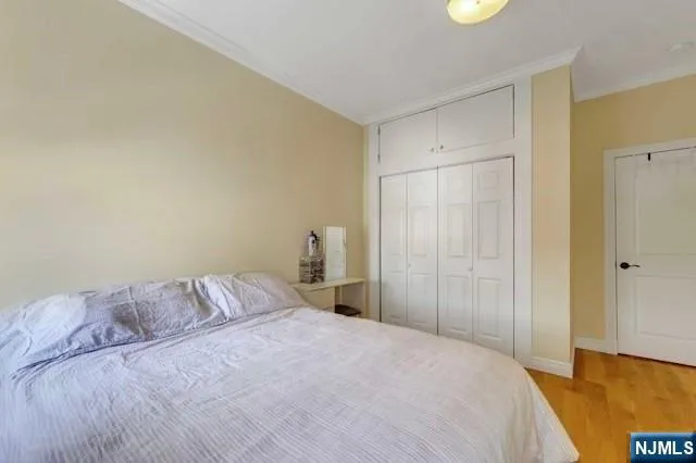 a bedroom with a bed and a night stand