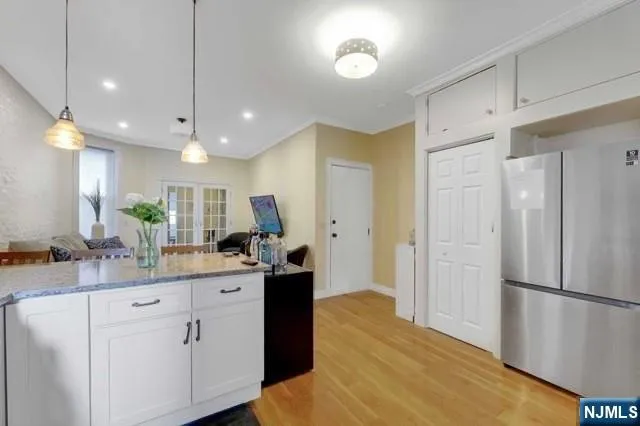 a kitchen with kitchen island a sink stainless steel appliances and cabinets