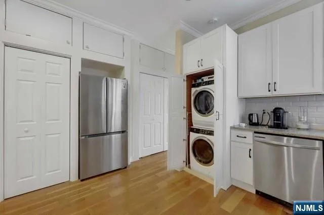 a kitchen with refrigerator and cabinets