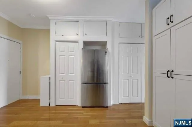 a view of empty room with wooden floor