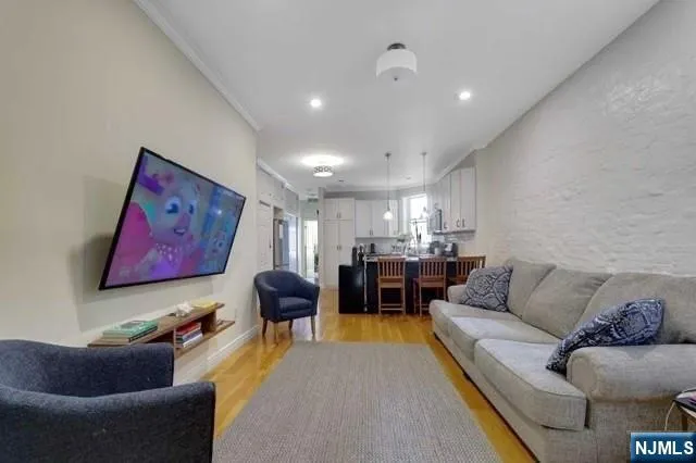 a living room with furniture and kitchen view