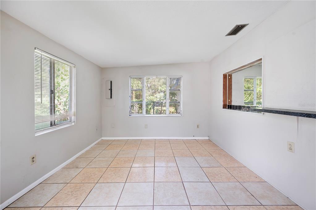 3221 Crutchfield Road Lakeland, FL 33805 - Photo 13 of 49 a view of an empty room with window and chandelier fan