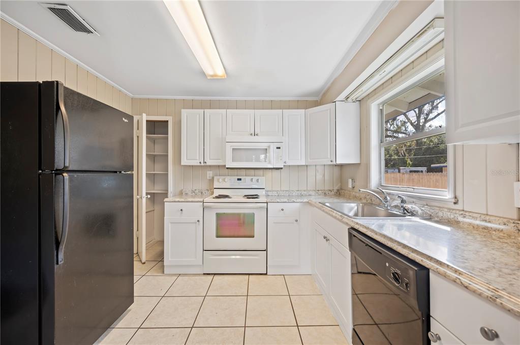 3221 Crutchfield Road Lakeland, FL 33805 - Photo 22 of 49 a kitchen with a refrigerator sink and cabinets