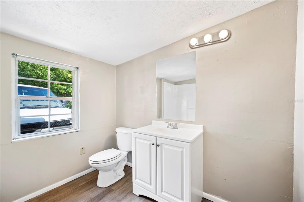 3221 Crutchfield Road Lakeland, FL 33805 - Photo 25 of 49 a white toilet sitting next to a bathroom sink