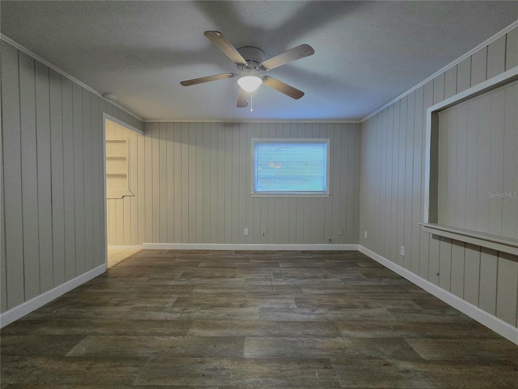 3221 Crutchfield Road Lakeland, FL 33805 - Photo 34 of 49 a view of an empty room with wooden floor and a window