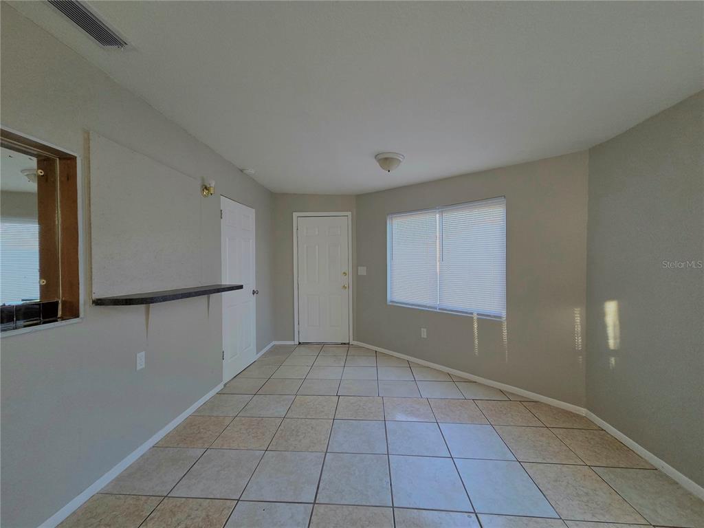 3221 Crutchfield Road Lakeland, FL 33805 - Photo 38 of 49 a view of an empty room with window and chandelier