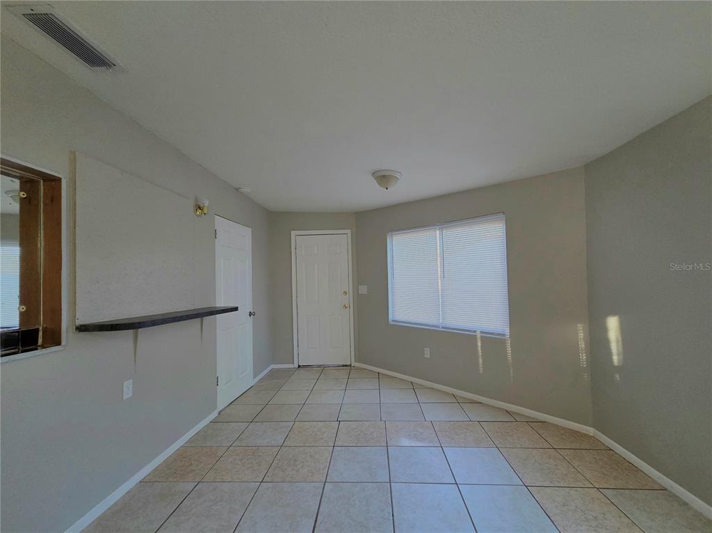 3221 Crutchfield Road Lakeland, FL 33805 - Photo 39 of 49 a view of an empty room with window and chandelier fan