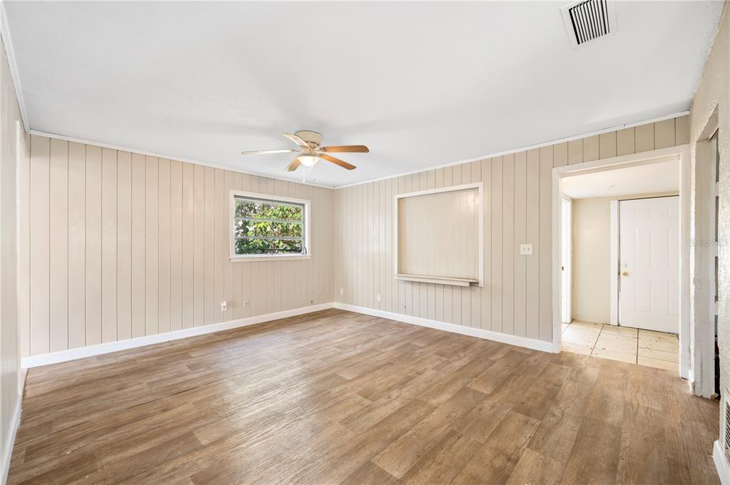 3221 Crutchfield Road Lakeland, FL 33805 - Photo 6 of 49 a view of an empty room with window and wooden floor
