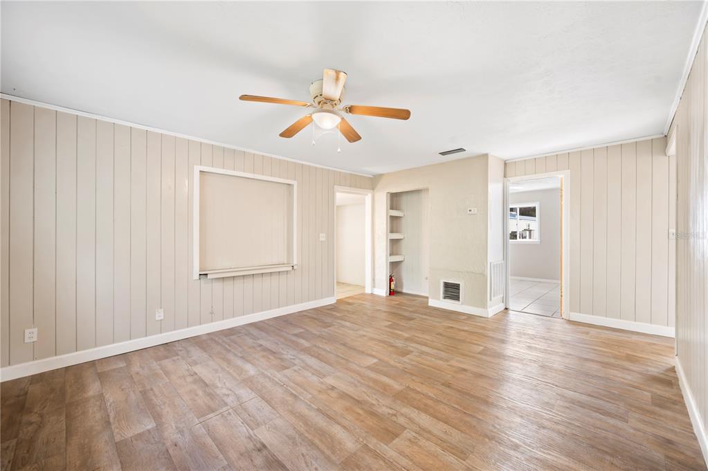 3221 Crutchfield Road Lakeland, FL 33805 - Photo 7 of 49 a view of empty room with wooden floor and fan