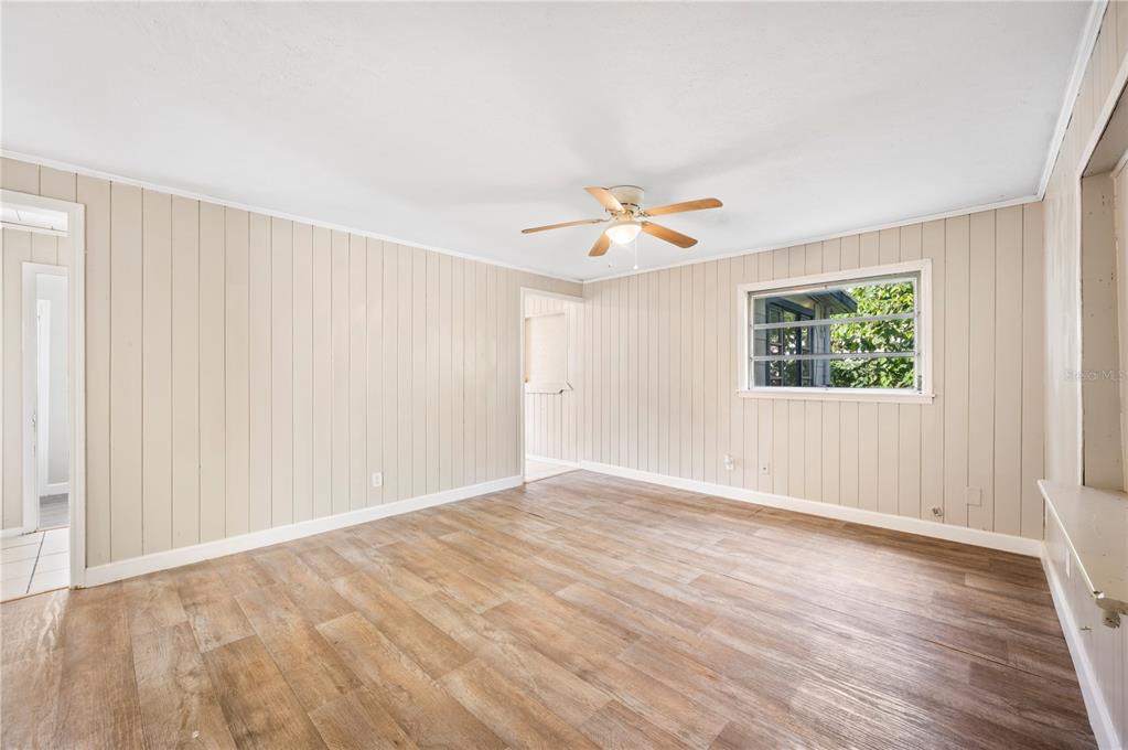 3221 Crutchfield Road Lakeland, FL 33805 - Photo 8 of 49 an empty room with wooden floor and window