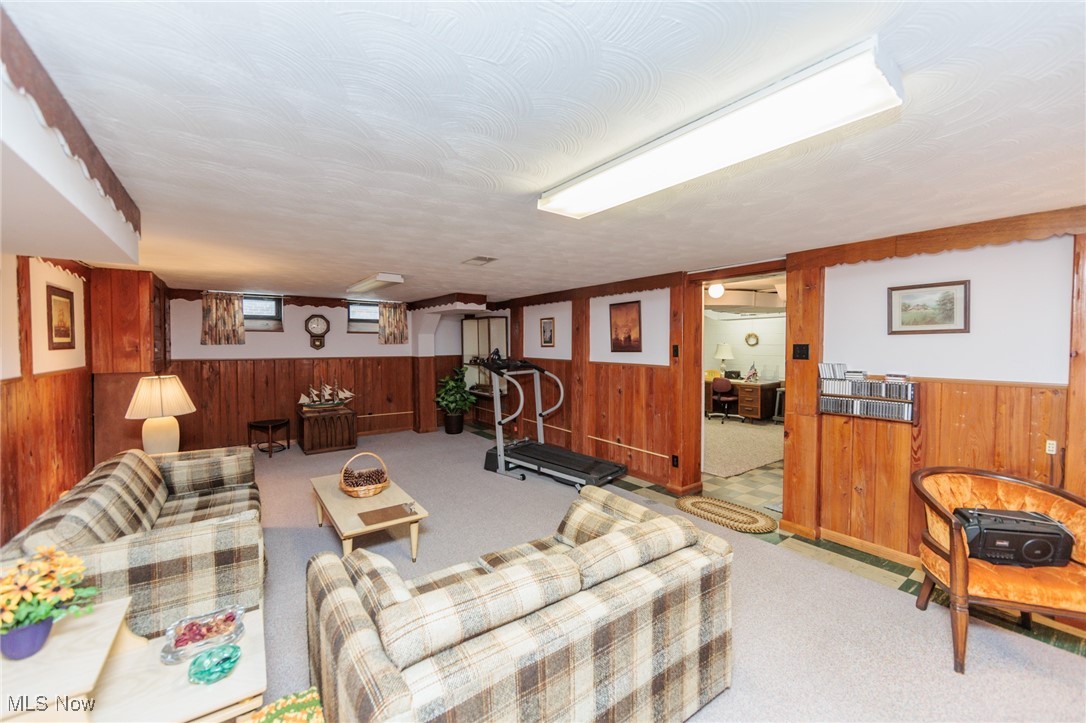 6192 Stanbury Road Parma, OH 44129 - Photo 46 of 49 Living area featuring wooden walls, carpet floors, and a wainscoted wall