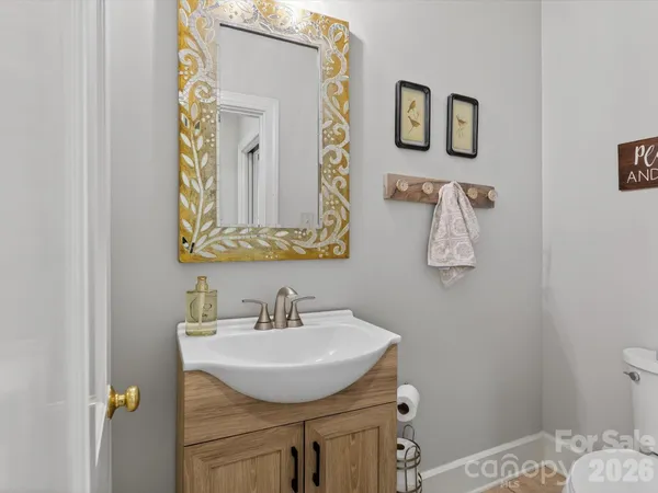 a spacious bedroom with a bed a mirror and a large window