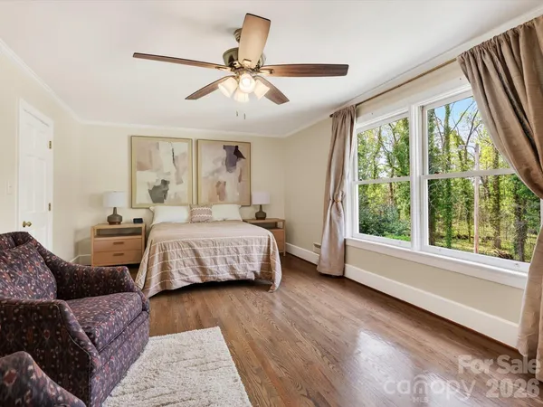 a living room with a bed furniture and a large window