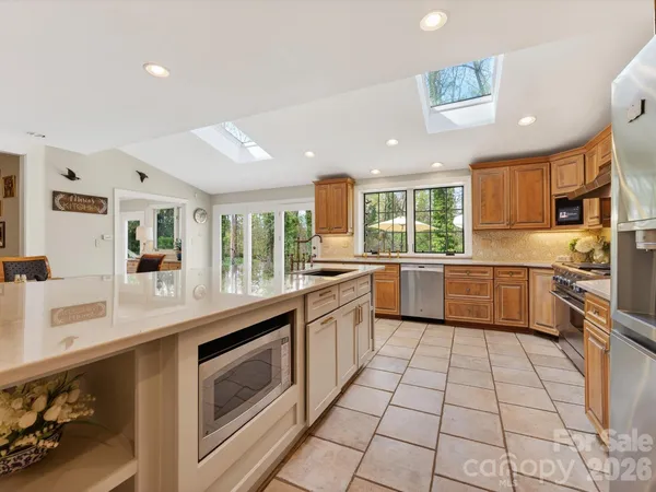 a kitchen with a sink stainless steel appliances and cabinets