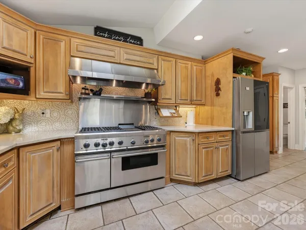 a kitchen with a stove and a refrigerator
