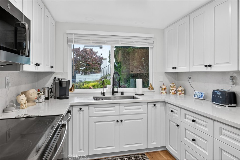 5 Cypress Way Rolling Hills Estates, CA 90274 - Photo 25 of 45 a kitchen with stainless steel appliances white cabinets and a window