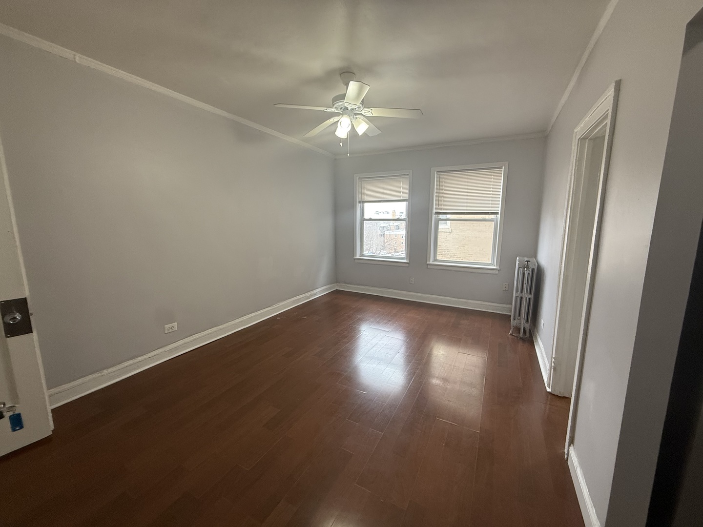 6930 North Greenview Avenue, Unit 509 Chicago, IL 60626 - Photo 5 of 10 an empty room with wooden floor and windows