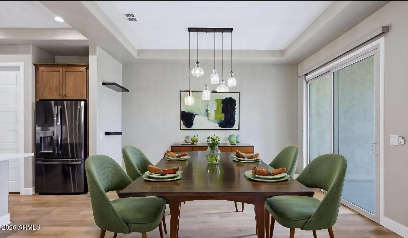 16849 West Merrell Street Goodyear, AZ 85395 - Photo 12 of 35 a view of a dining room with furniture window and wooden floor