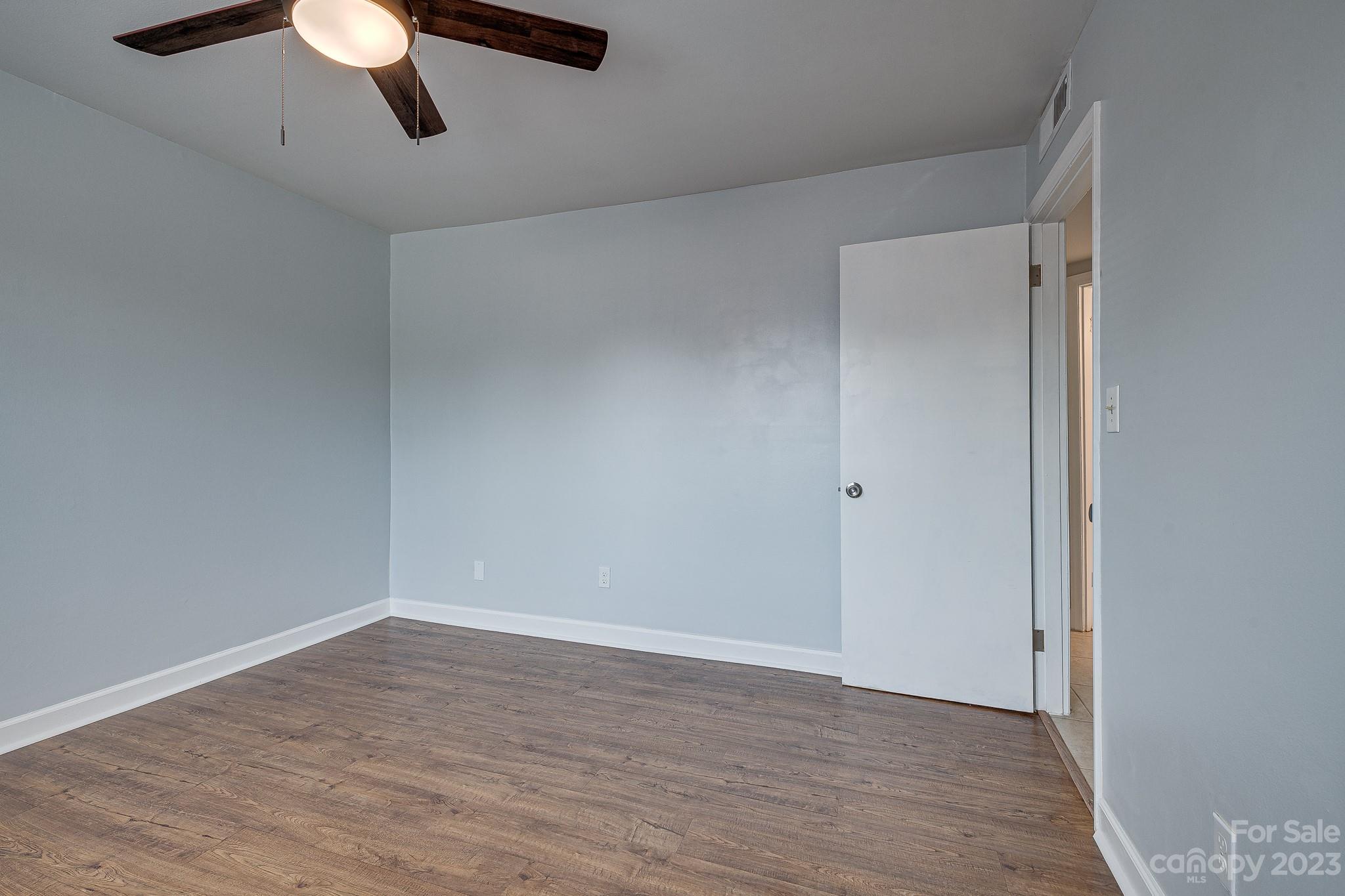 910 McAlway Road, Unit B Charlotte, NC 28211 - Photo 23 of 37 a view of an empty room with wooden floor