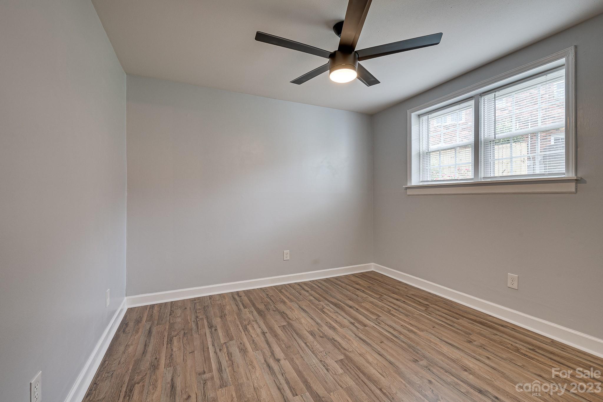910 McAlway Road, Unit B Charlotte, NC 28211 - Photo 25 of 37 wooden floor in an empty room with a window