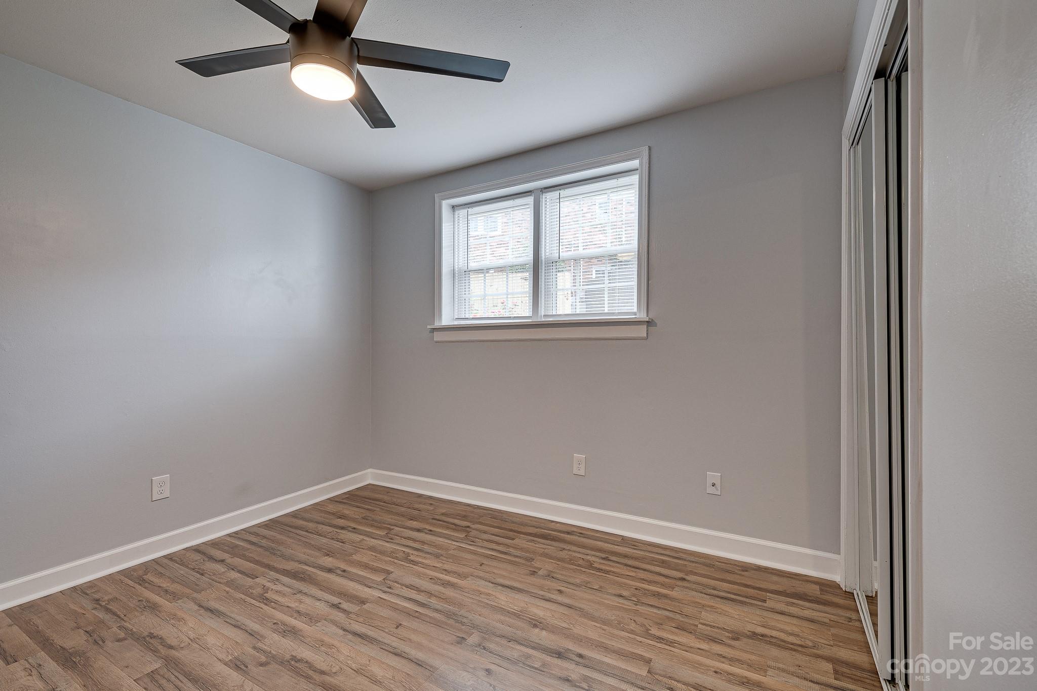 910 McAlway Road, Unit B Charlotte, NC 28211 - Photo 26 of 37 an empty room with a window and a ceiling fan