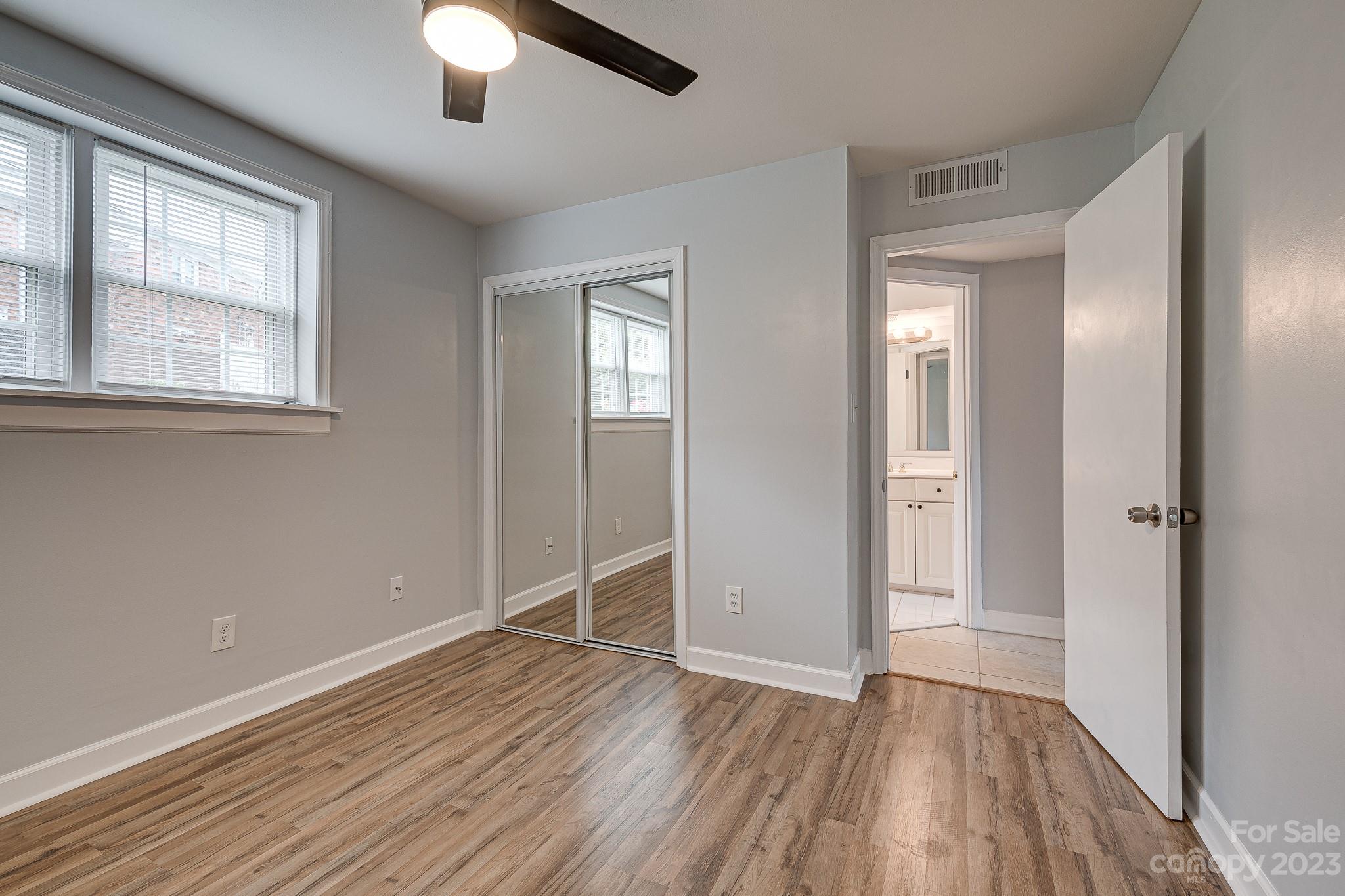 910 McAlway Road, Unit B Charlotte, NC 28211 - Photo 27 of 37 wooden floor in an empty room with a window