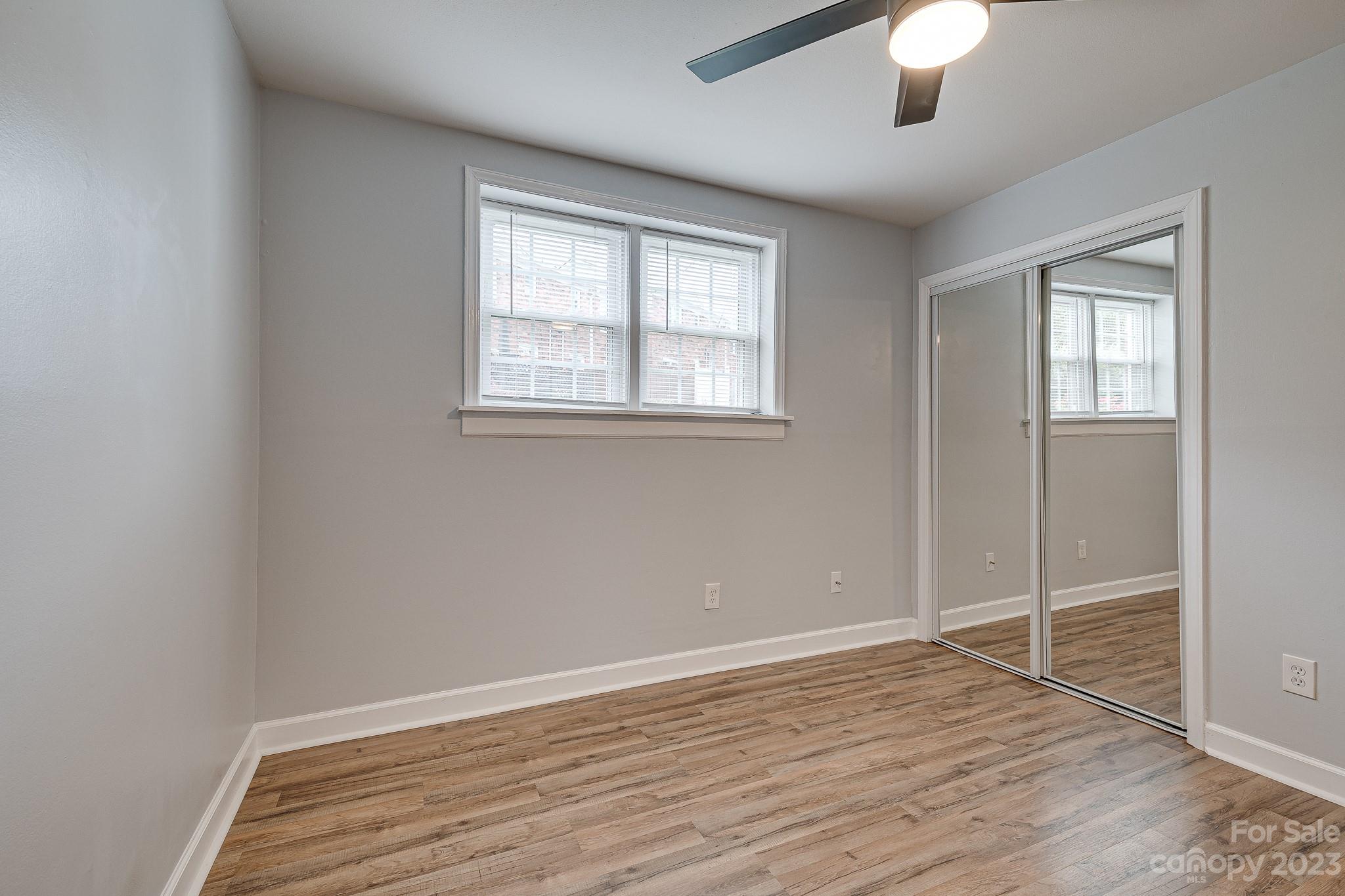 910 McAlway Road, Unit B Charlotte, NC 28211 - Photo 28 of 37 a view of an empty room with wooden floor and a window