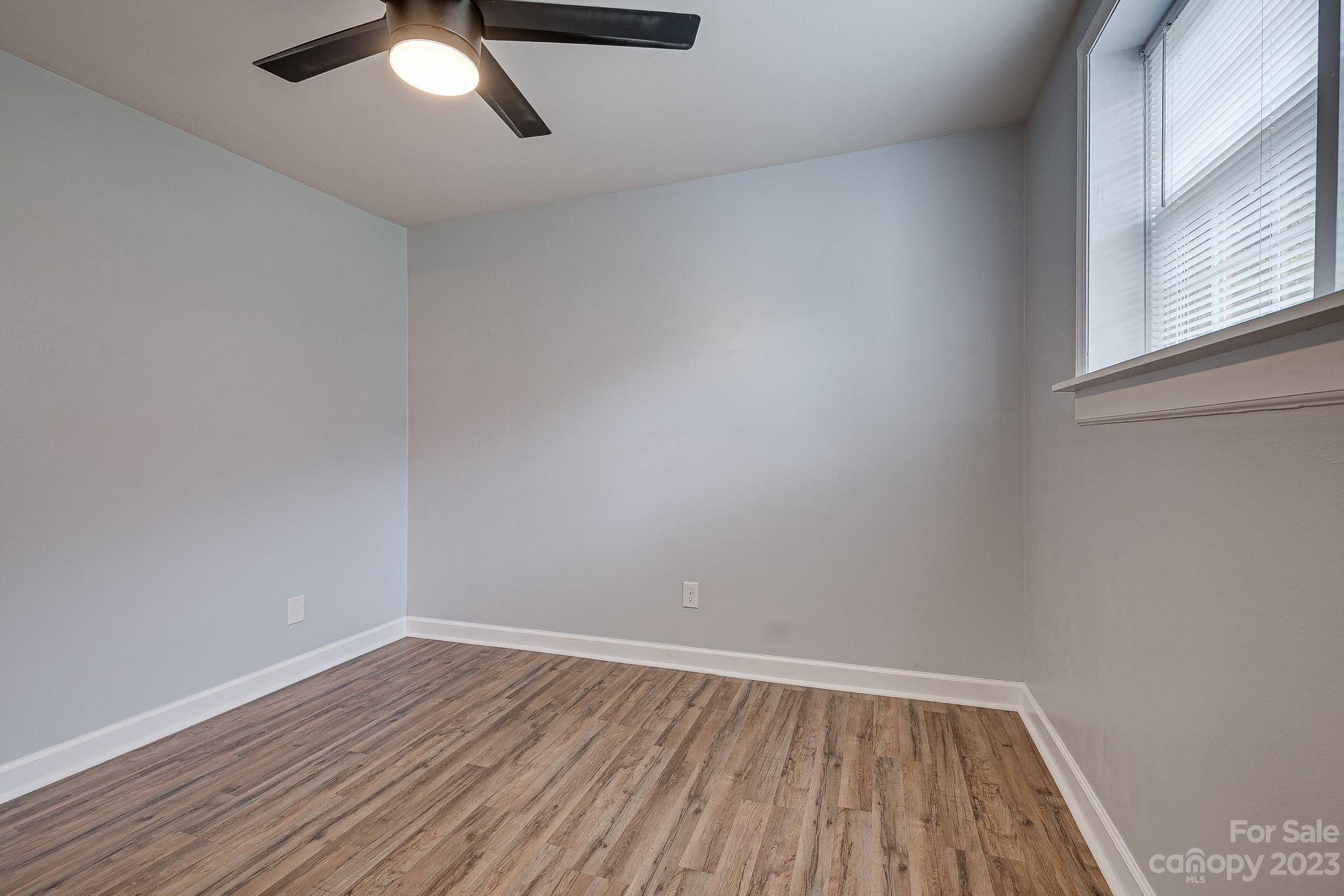 910 McAlway Road, Unit B Charlotte, NC 28211 - Photo 30 of 37 a view of an empty room with wooden floor and a window