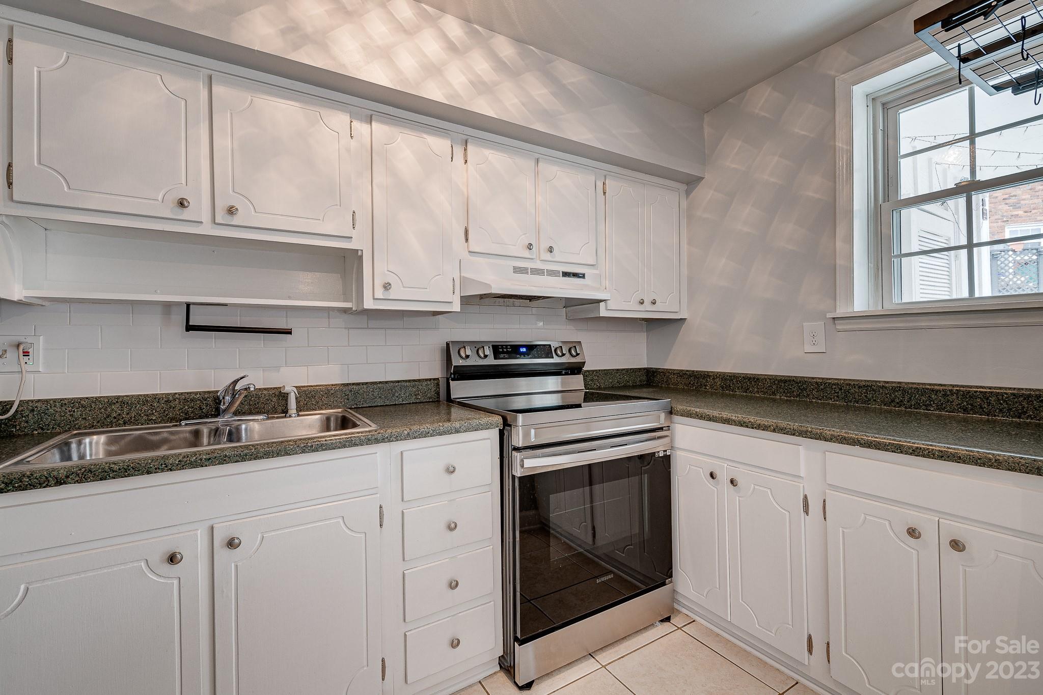 910 McAlway Road, Unit B Charlotte, NC 28211 - Photo 3 of 37 a kitchen with granite countertop white cabinets white stainless steel appliances and a sink