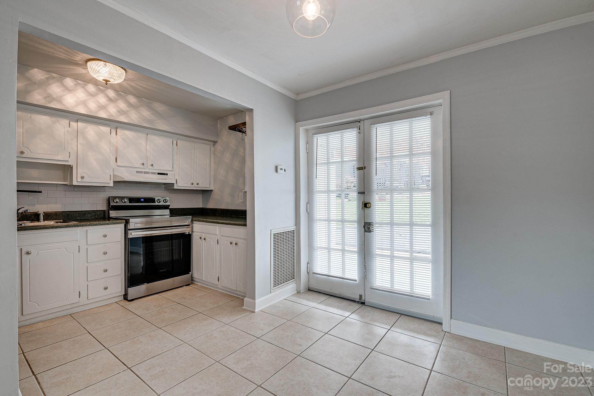 910 McAlway Road, Unit B Charlotte, NC 28211 - Photo 7 of 37 a kitchen with a stove a sink and a cabinets