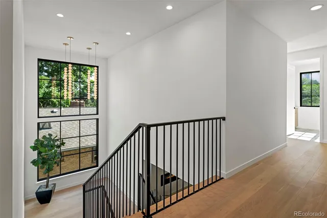 a view of a hallway with wooden floor to ceiling window and wooden floor