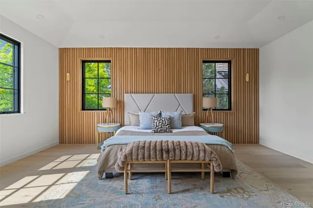 a bedroom with a bed lamp and a window