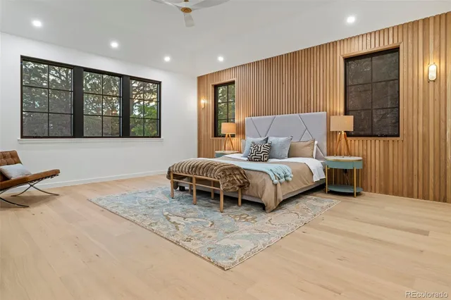 a spacious bedroom with a bed and large window