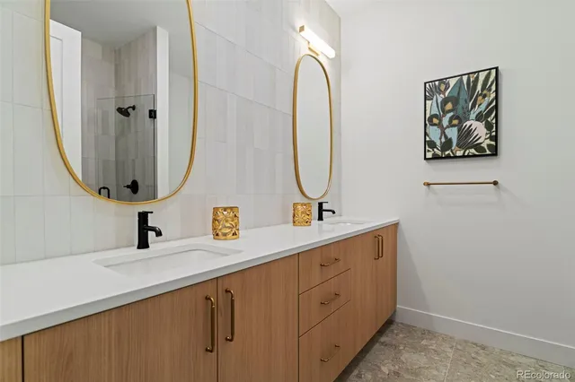 a bathroom with a double vanity sink and a mirror