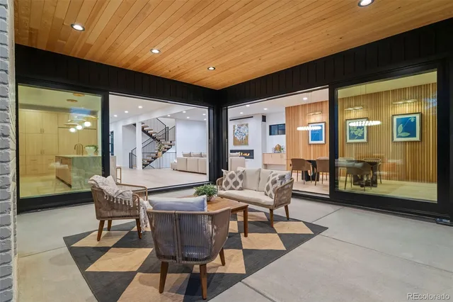 a dining room with furniture a rug and a large window