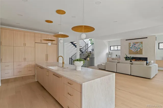 a kitchen with a sink cabinets and wooden floor