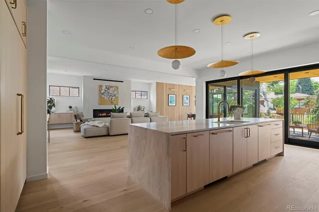 a large white kitchen with a large window and couch