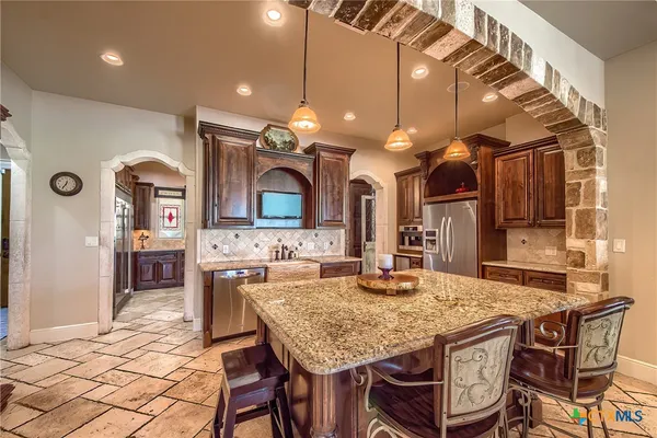 a kitchen with a table and chairs in it