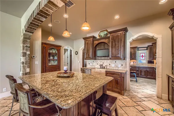 a kitchen with a table and chairs in it