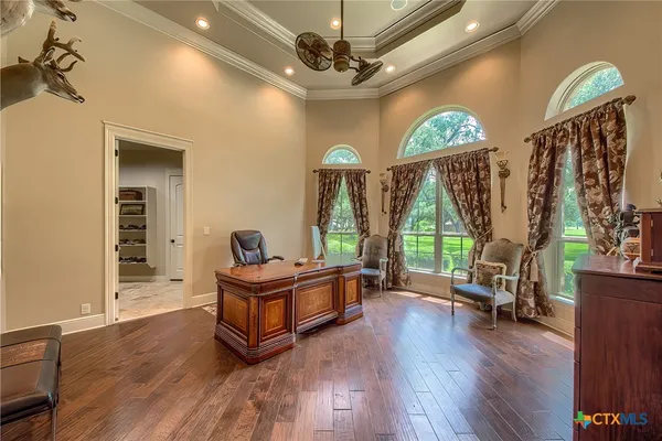 a living room with furniture a window and wooden floor