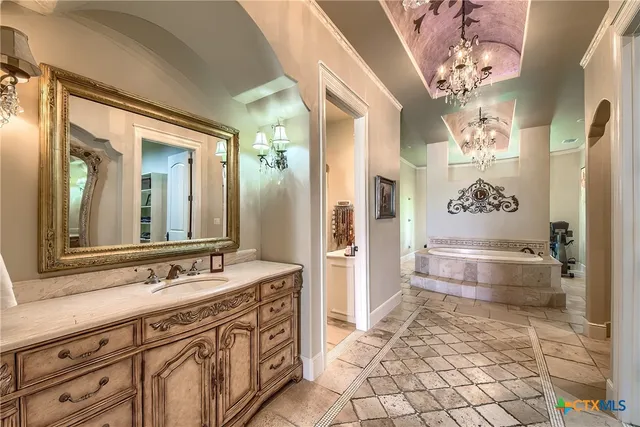 a spacious bathroom with a sink a vanity and a mirror