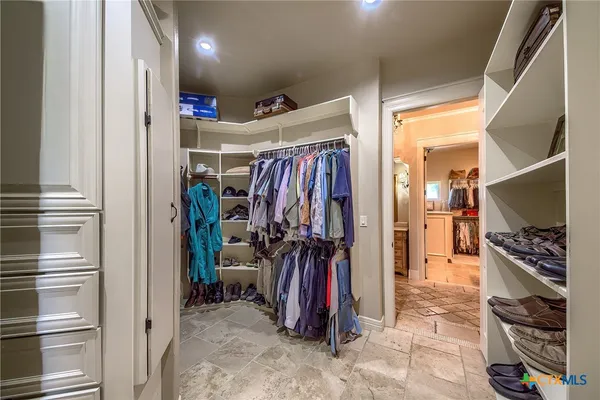 a view of a walk in closet with a fireplace