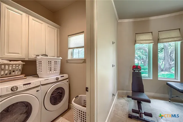 a view of washer and dryer sitting in a room next to a window