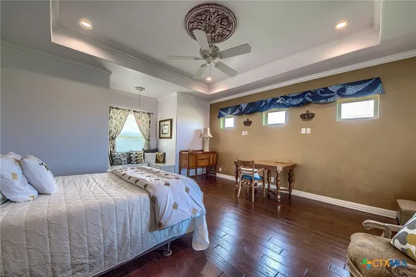 a bedroom with a bed and a chandelier